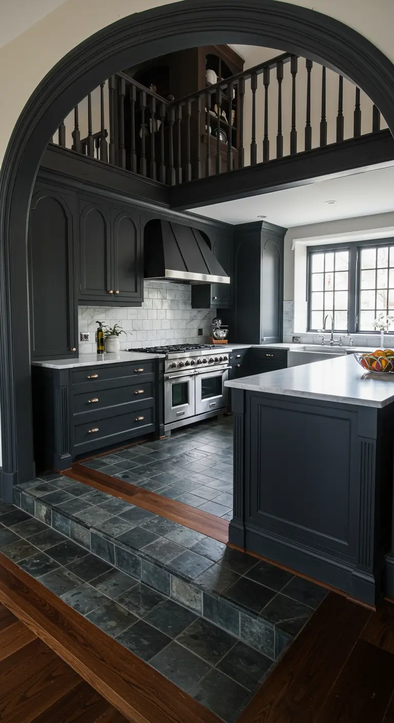 View of a sunken black kitchen through a large matching archway, with slate steps leading down.