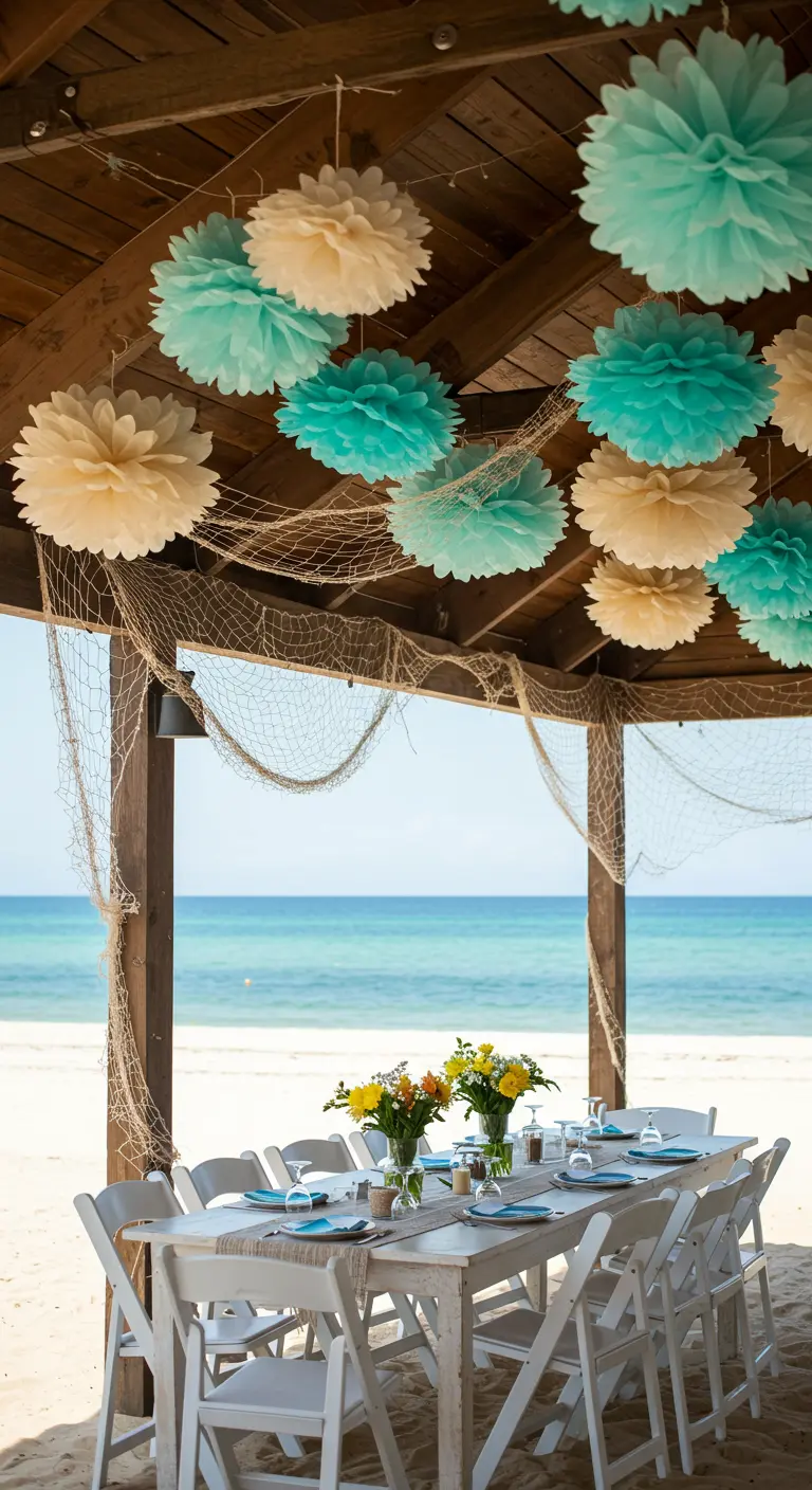 Seafoam green and cream pom-poms hang with draped fishnets in a beachside cabana.