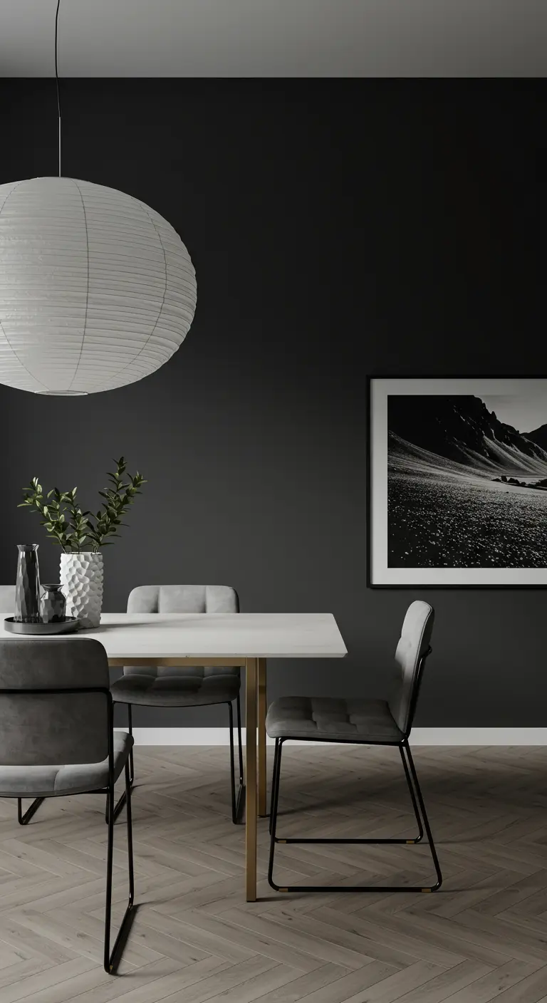 Minimalist dining room with charcoal walls, a large white paper lantern, and simple grey chairs.