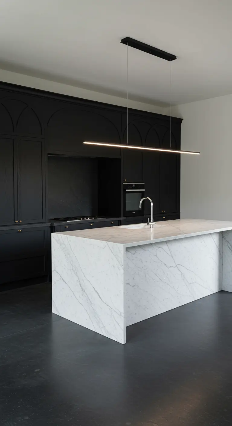 Minimalist kitchen with clean-lined black arched cabinets and a stark white marble island.