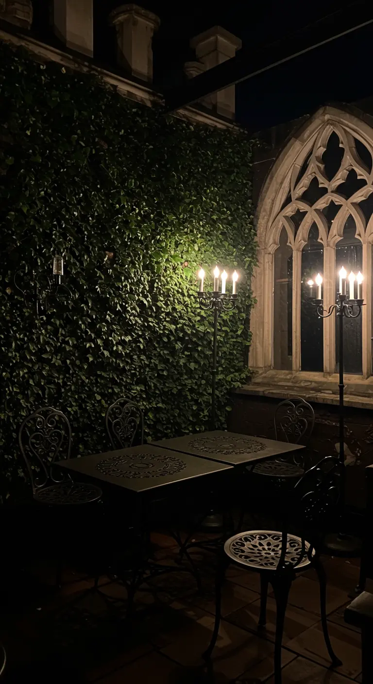 A moody, gothic-inspired rooftop nook at night, lit by tall candelabras.