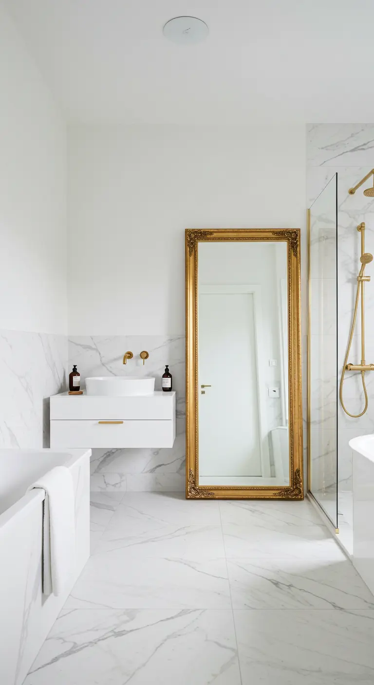 Minimalist white marble bathroom with a large, ornate gold-framed floor mirror.