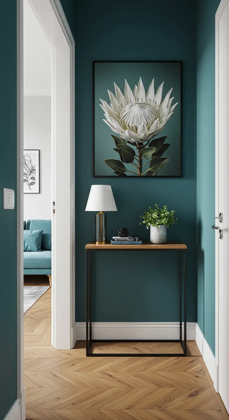 A large, dramatic print of a white protea flower in a hallway with dark teal walls.
