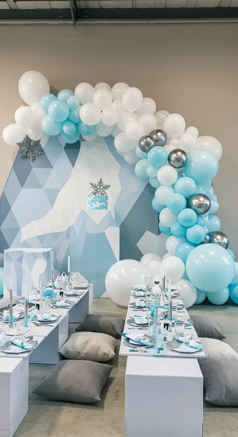 Modern party setup with a geometric backdrop, floor cushions, and low tables.