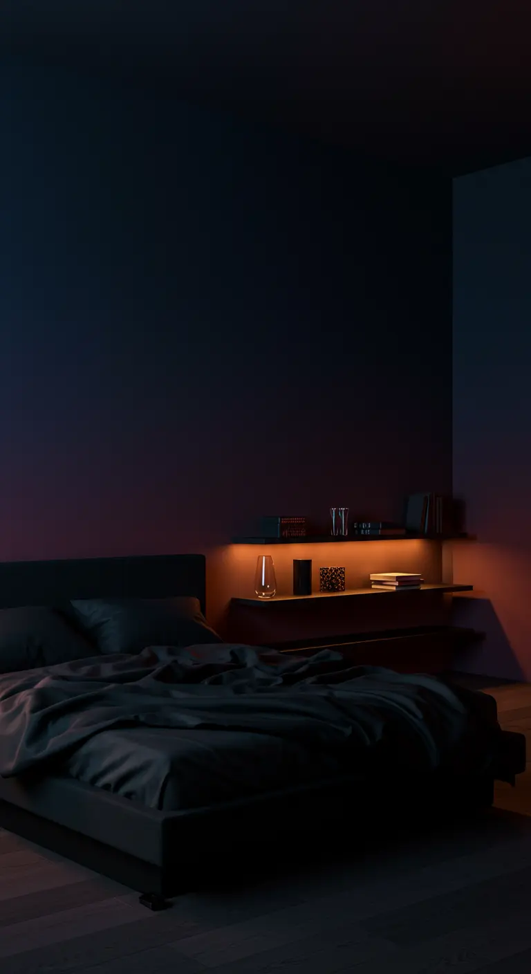 A dark, moody bedroom with a subtle gradient wall and warm light from a floating shelf.