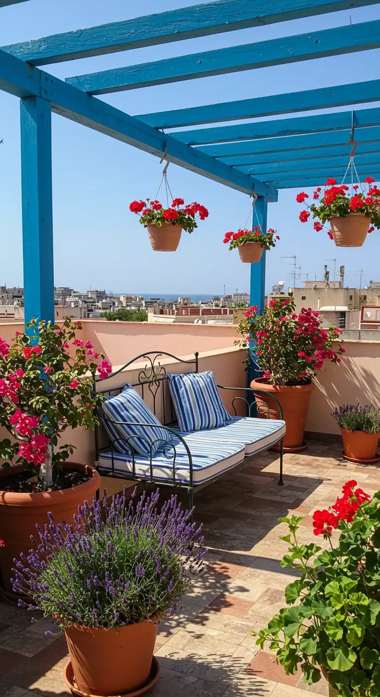 Sunny rooftop terrace with a blue pergola, iron bench, and pots of red geraniums.