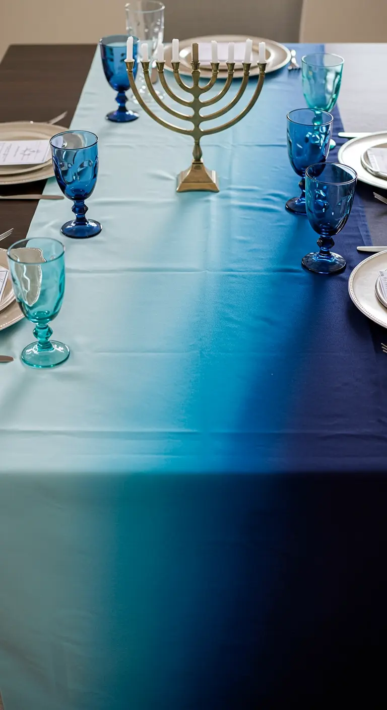 A Hanukkah table set with a striking blue ombré tablecloth and blue goblets.