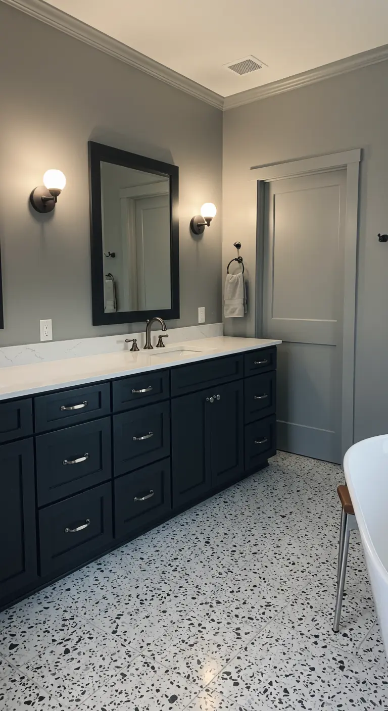 Bathroom with dark gray shaker cabinets and a black-and-white terrazzo floor.